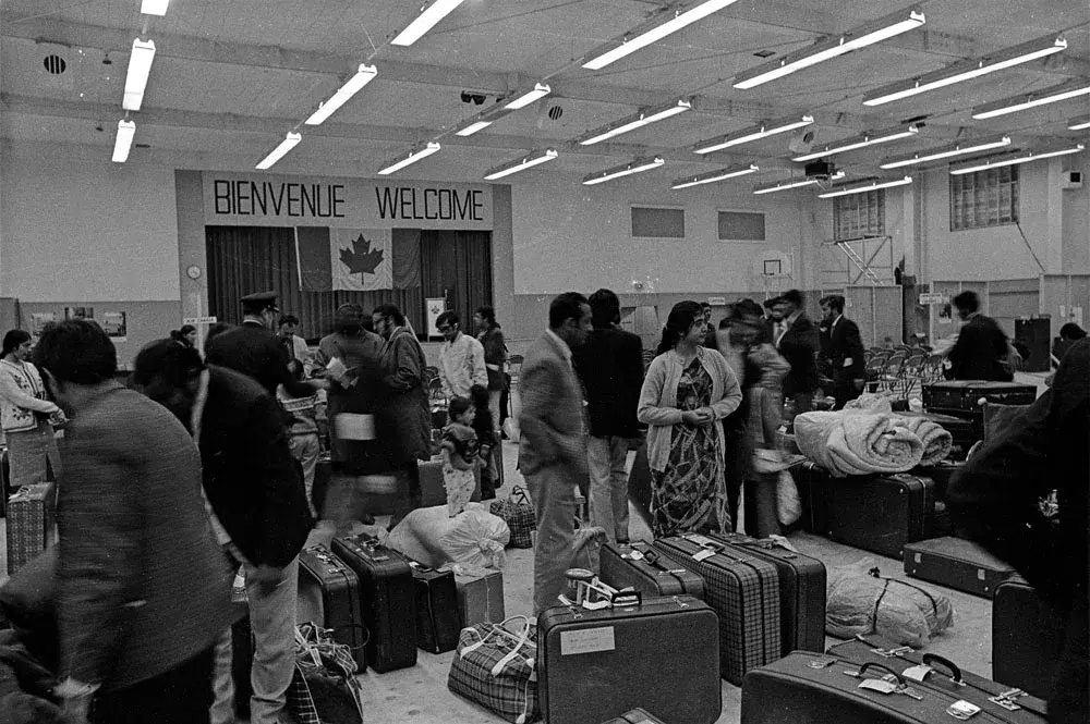 Asian Ugandan refugees and their luggage inside a Canadian reception centre in 1972.